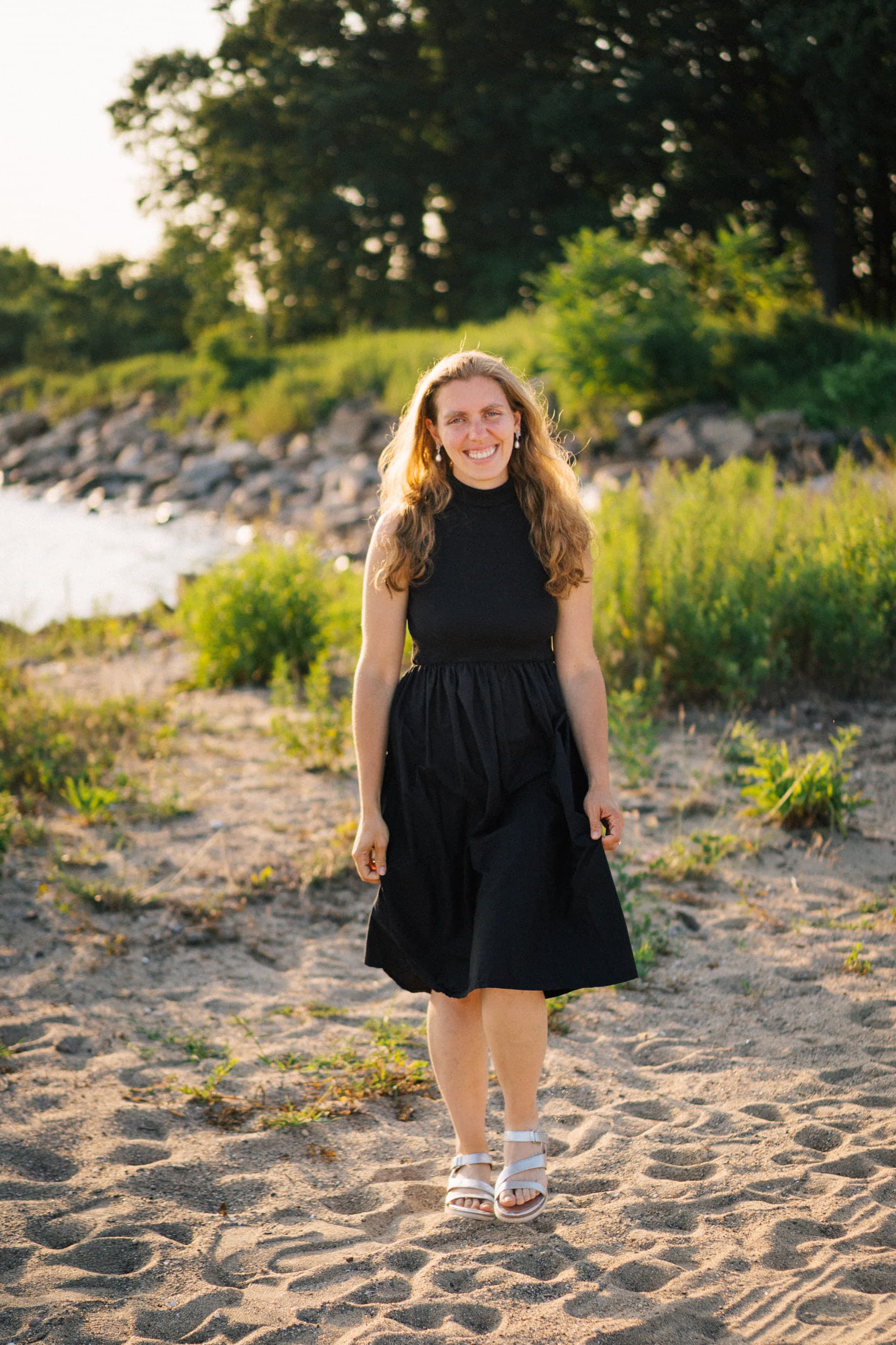 Beth Zink Linke standing on a beach at golden hour