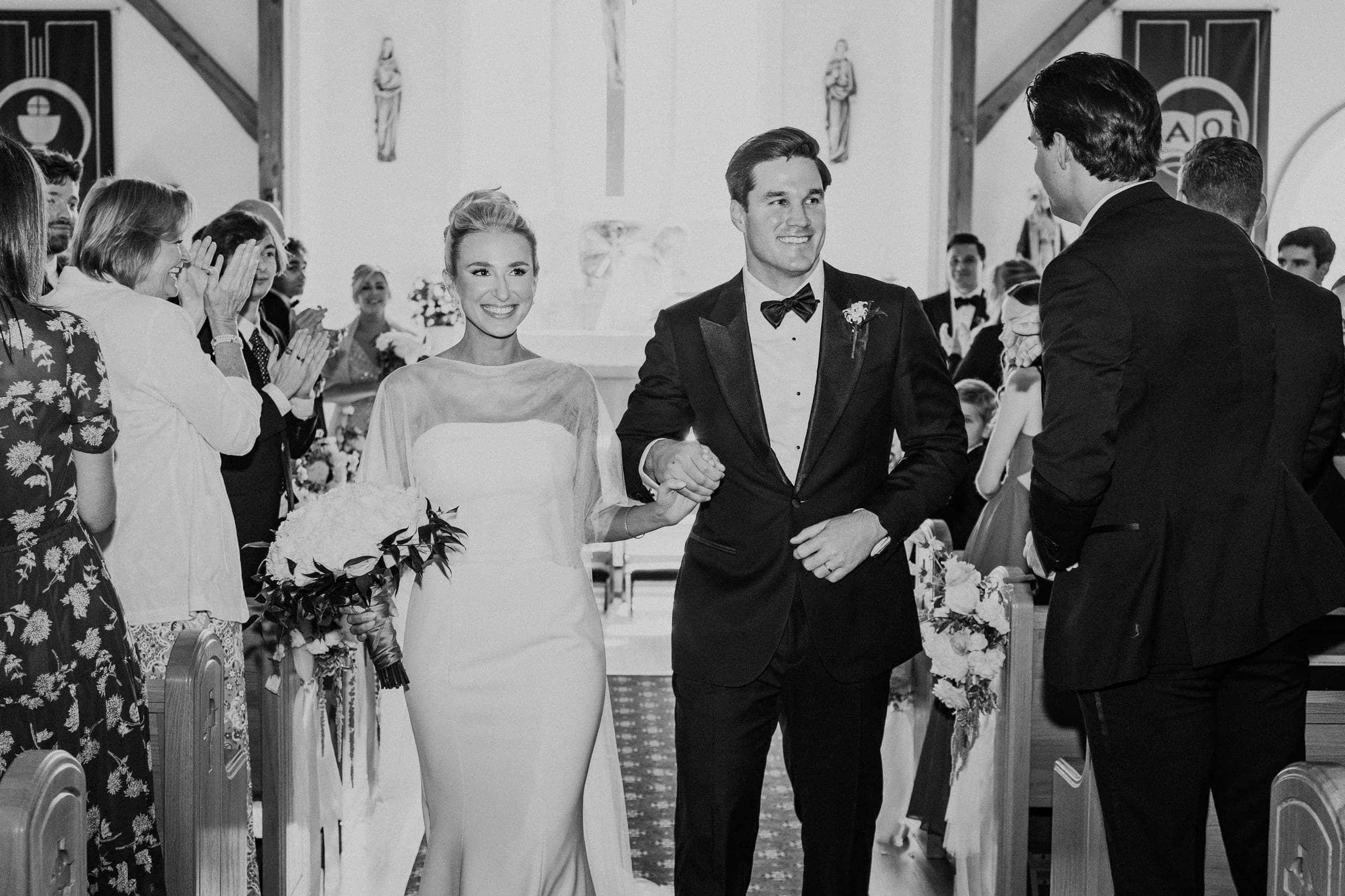 The recessional through applauding pews, black and white