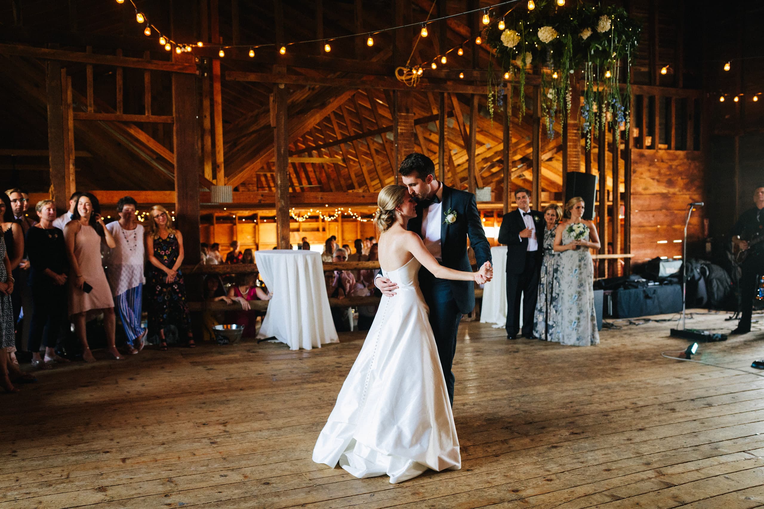 The first dance in the old barn, string lights overhead