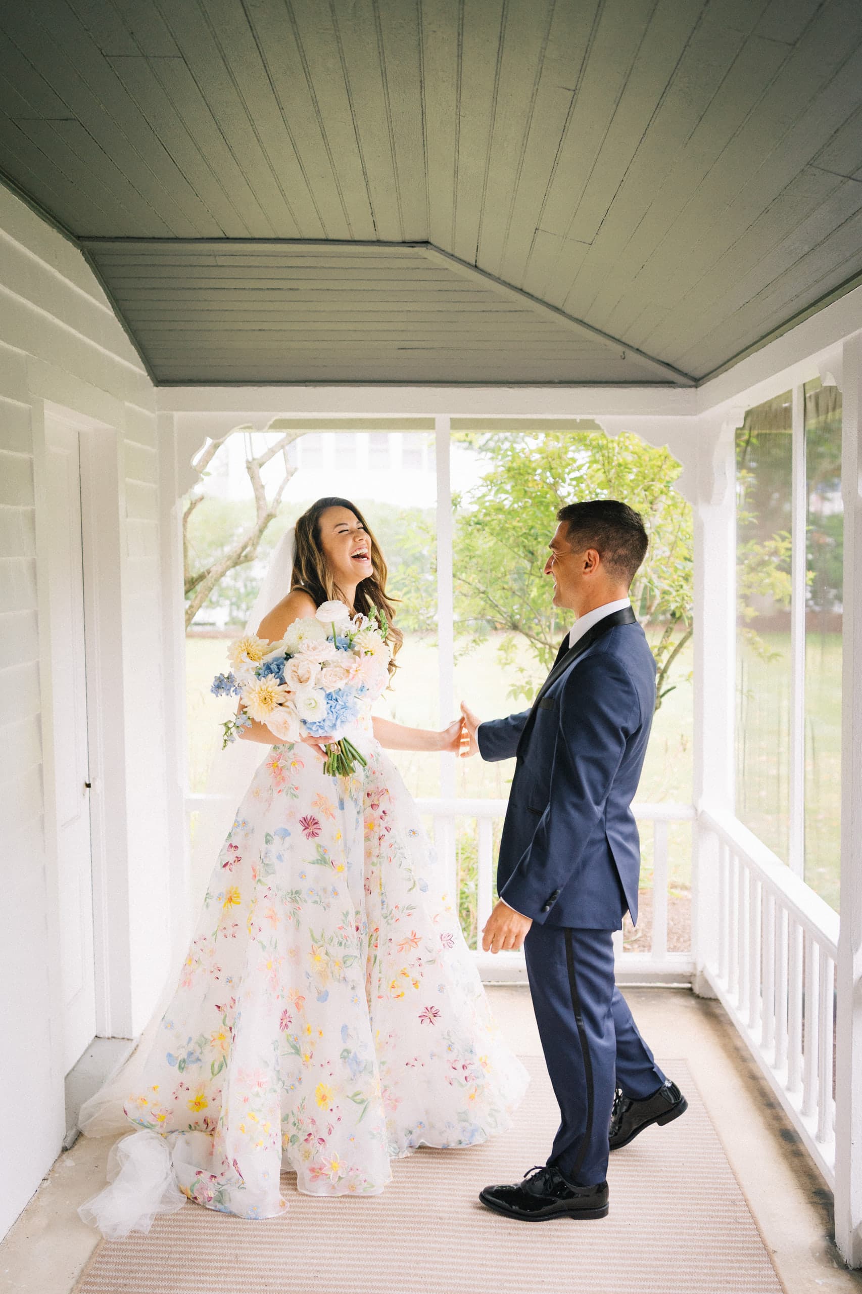 Laughing together on the porch, her gown scattered with watercolor flowers