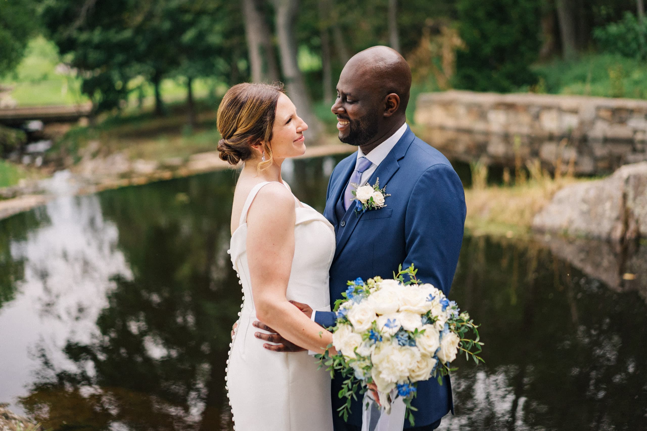 Face to face at the edge of a quiet pond, bouquet of white and blue