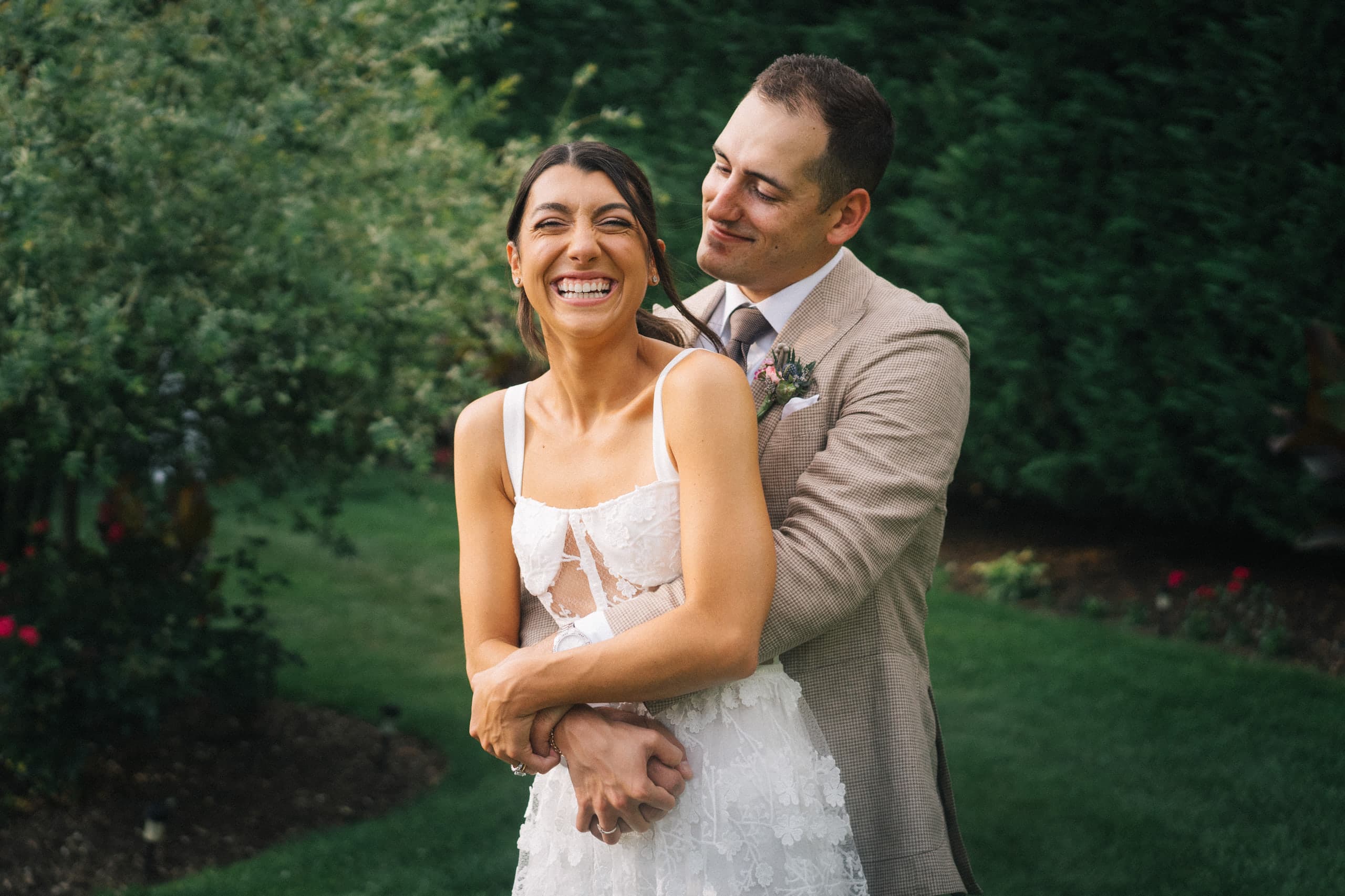Wrapped in his arms in the garden, laughing