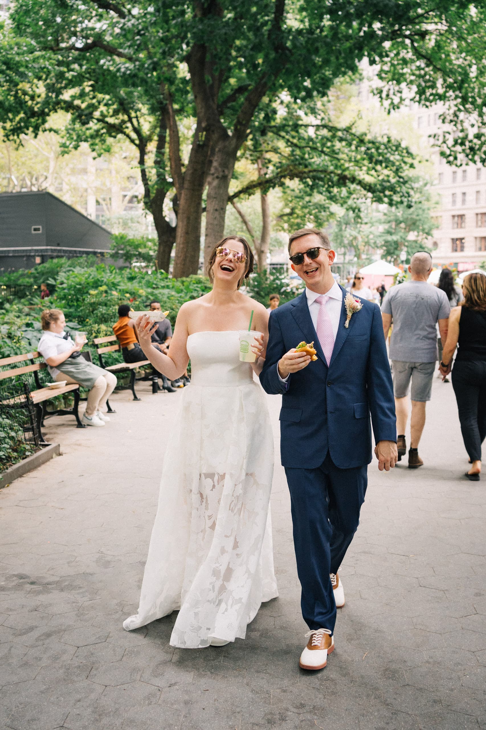 Strolling through the park with drinks in hand, laughing