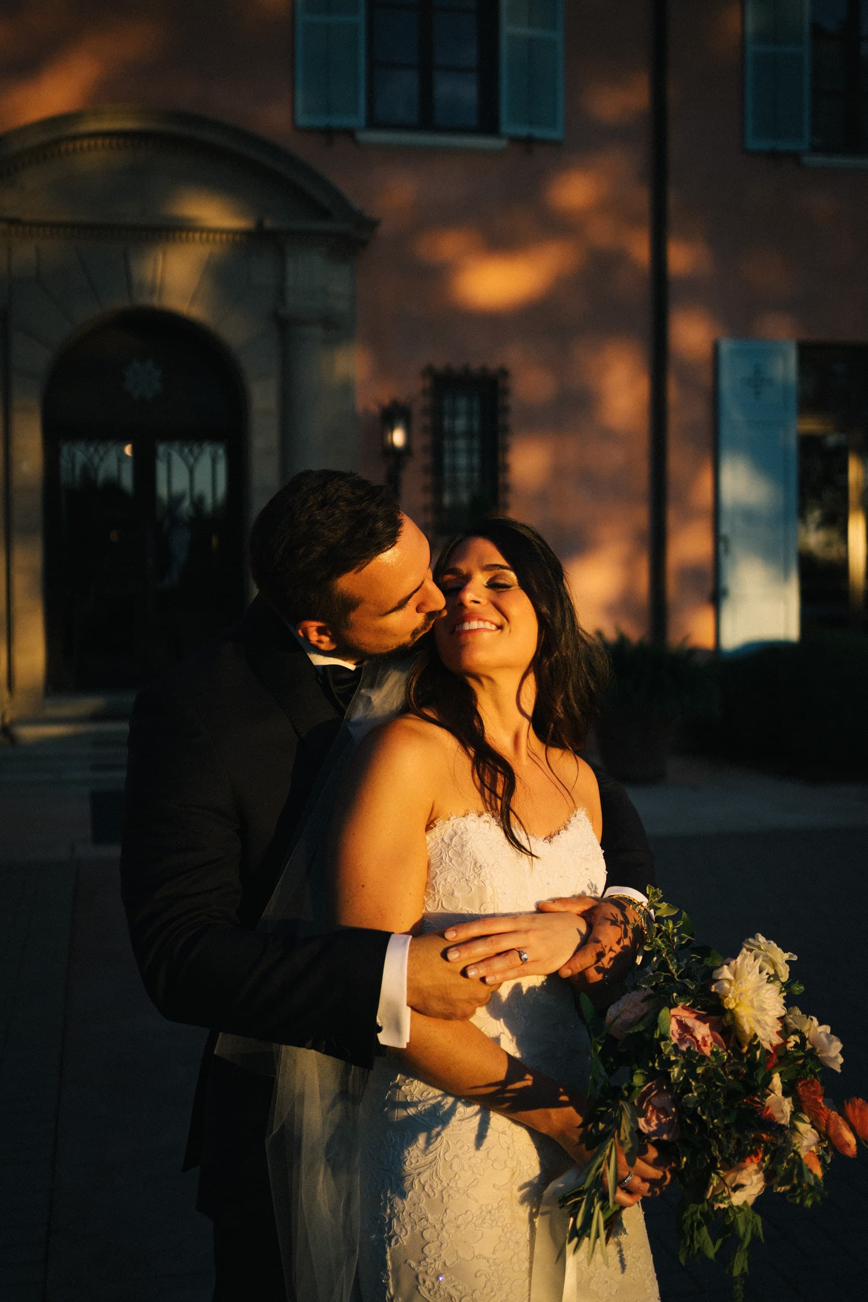 A kiss on the cheek in the last amber light before the villa